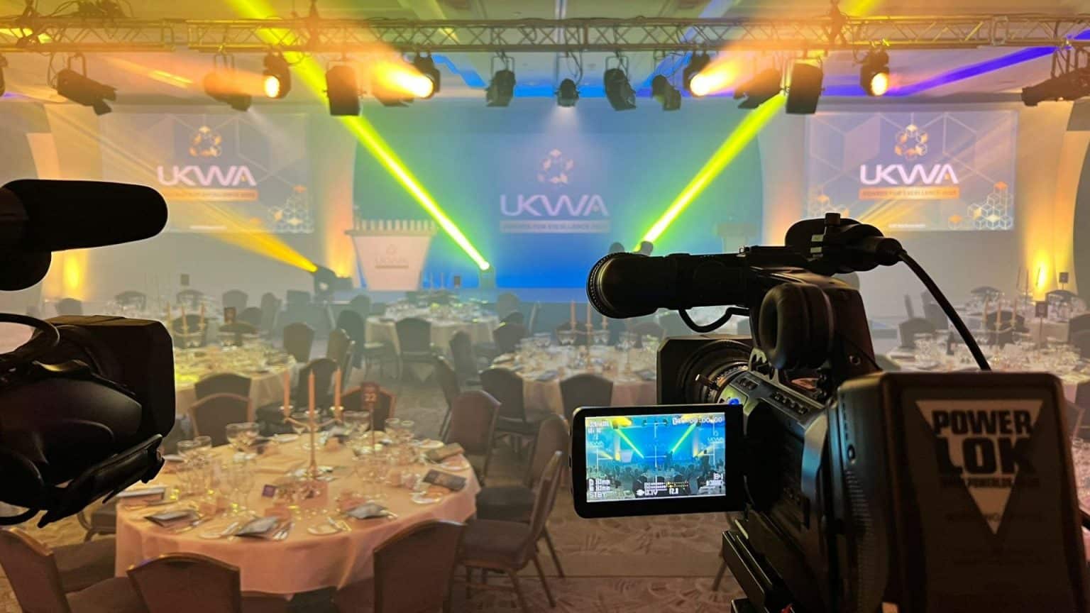Behind the scenes camera shot of room set up for awards event.