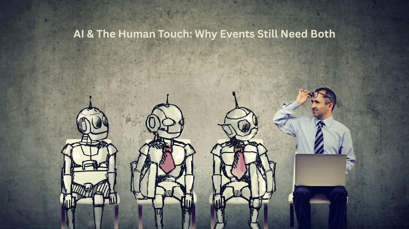 Image of robots and a human with laptop